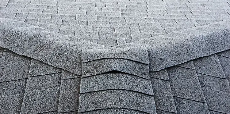 Asphalt shingle roof ridge up close