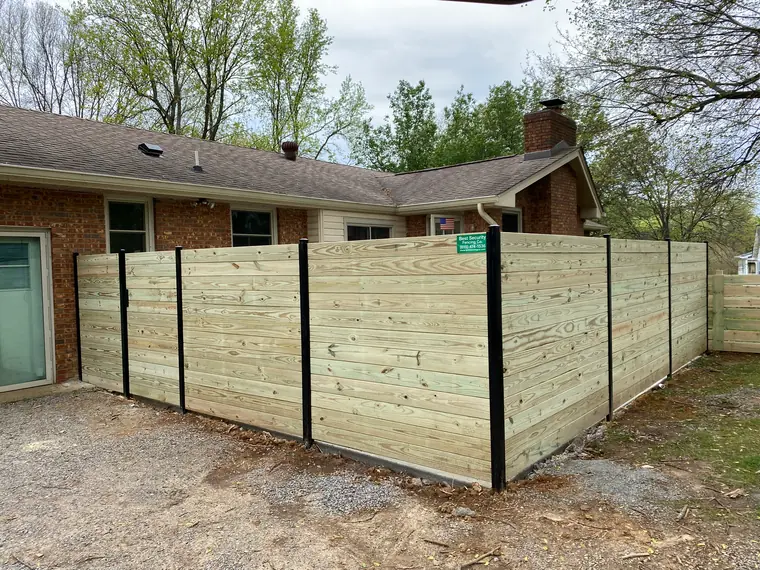 Horizontal boards set between black posts