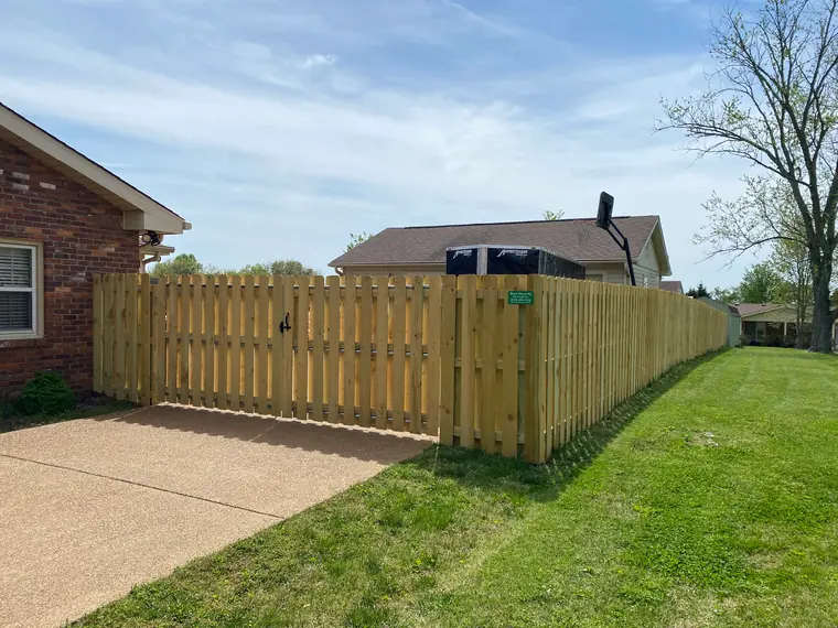 Wood driveway gate and fence line