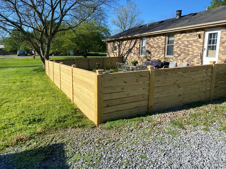 Horizontal board fence around a back yard