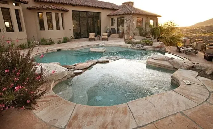 Natural freeform pool with stone coping