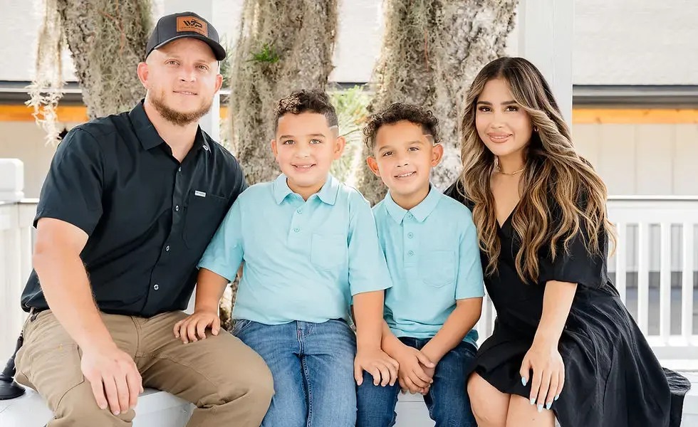 The Wave Plumbing family, all four smiling on a bench
